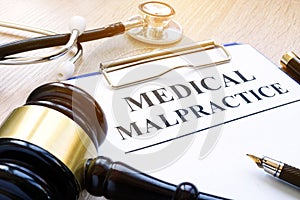 Documents about medical malpractice and gavel.