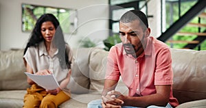 Documents, stress for debt and couple with financial crisis on sofa in living room of home for problem solving. Tax