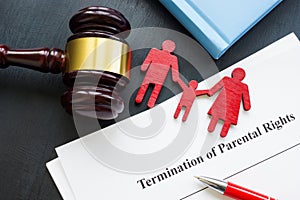 Documents about Termination of parental rights and family figurines.