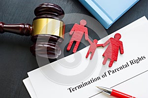 Documents about Termination of parental rights and family figurines. photo