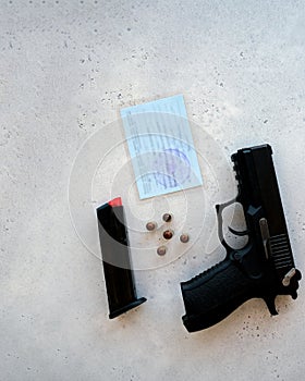 A handgun with bullets symbolizing gun rights while framed against the United States constitution.