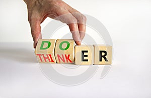 Doer or thinker symbol. Concept words Doer or thinker on wooden cubes. Businessman hand. Beautiful white table white background.