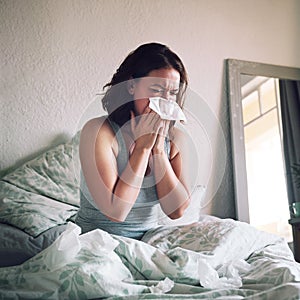 Does anybody know a quick way to relieve the flu. an attractive young woman suffering with the flu while sitting on her