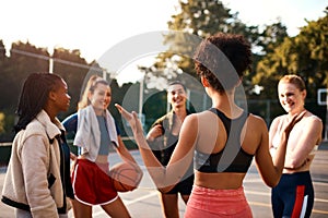 Does anyone have a game plan for the day. a diverse group of friends getting ready to play a game of basketball together