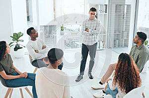 Does anyone want to share first. a handsome young man standing and talking to his support group.