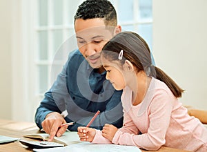 Does that make sense. Cropped shot of an adorable little girl doing her homework with some help from her dad.