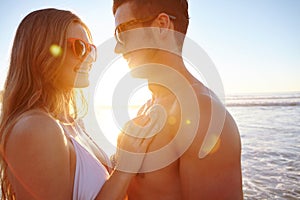 It doesnt get anymore romantic than this...a young couple enjoying a romantic moment at the beach.