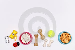 Dog accessories, food and toy on white background. Flat lay. Top