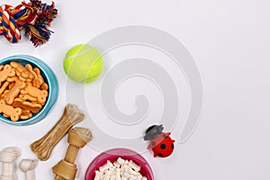 Dog accessories, food and toy on white background. Flat lay. Top view.