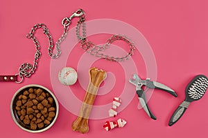 Dog accessories on pink background. Top view. Pets and animals concept photo