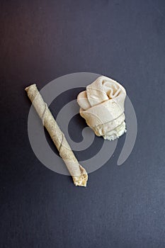 Dog bone, Ate Dog treats, Rawhide dog chews on black background, Close up shot, Snack food dog