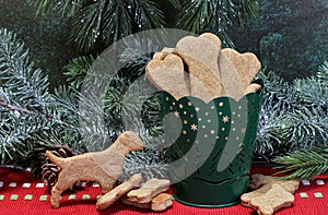 Dog bone cookies in a container in a Christmas setting