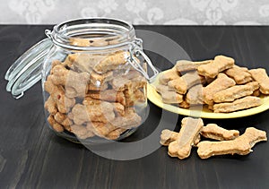 Dog bones in a canister and on a wooden counter. Healthy homead