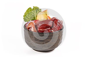 Dog bowl with mixture of biologically appropriate raw food containing meat chunks, fish, fruits and vegetables