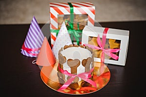 Dog cake and cookie in boxes with birthday hat