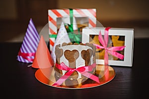 Dog cake and cookie in boxes with birthday hat