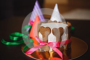 Dog cake decorated with bone cookies and birthday hat