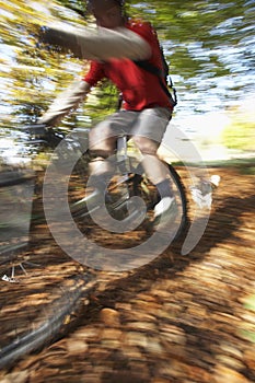 Dog Chasing Man On Mountain Bike
