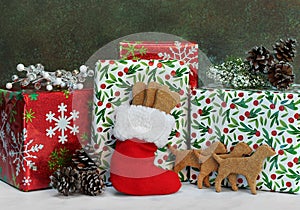 Dog cookies for Christmas in a stocking in front of wrapped gifts