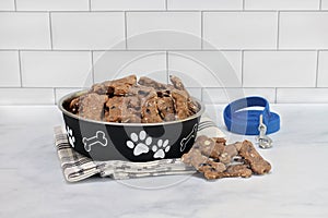 Dog cookies made with oats, blueberries and bananas on counter and in a cute dog bowl