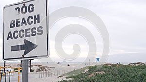 Dog friendly beach access road sign, California USA. Pet walking on ocean coast.