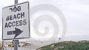 Dog friendly beach access road sign, California USA. Pet walking on ocean coast.