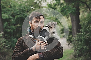 Dog and his owner - Cool dog and young man having fun in a park - Concepts of friendship,pets,togetherness