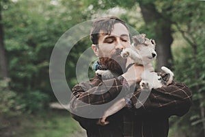 Dog and his owner - Cool dog and young man having fun in a park - Concepts of friendship,pets,togetherness