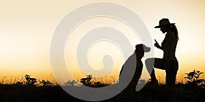 Dog and his trainer - silhouette image with blank, copy space