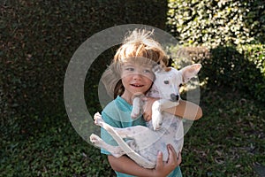 Dog and kid. Puppy with child. Happy boy hugging and playing with dogy. Kids adaptation.