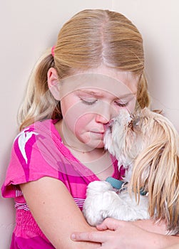 Dog licking childs face