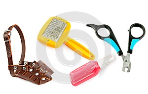 Dog muzzle, nail clipper, slicker and shampoo isolated on a white background. Collage