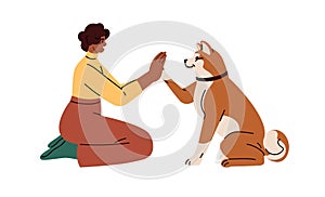 Dog owner training cute smart doggy to give high five, paw clapping hand. Human and obedient pet animal communication