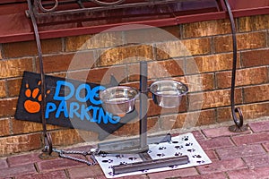 Dog parking area with a drinking bowl in front of the store door