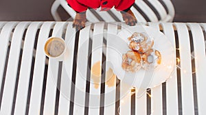 Dog paws on a table with dessert and coffee cup, top view