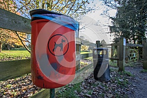 Dog poo waste litter bin. Trash can by park entrance.