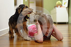 Dog pulling girls hair