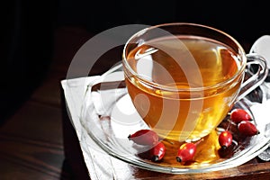 Dog rose herbal tea in a glass cup with hips red berry, vitamin infusion with vitamin C
