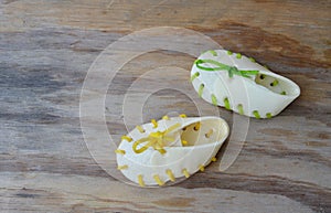 Dog snack shoe made by cow leather on wooden board