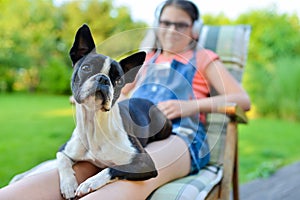 Dog and teenage girl resting in the garden