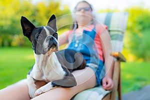 Dog and teenage girl resting in the garden