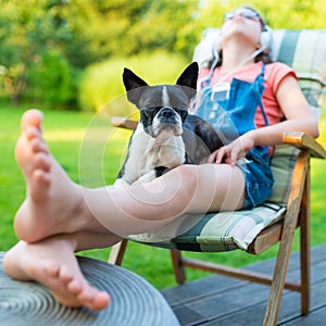 Dog and teenage girl resting in the garden