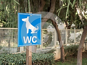 Dog toilet sign in a city park. Animal care. Close-up