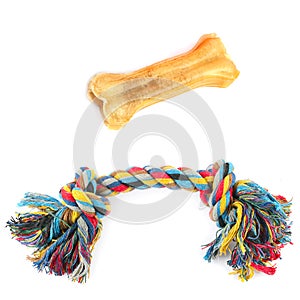 Dog toys, chewing bone and rope, isolated on white