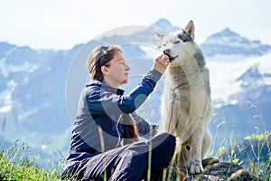 Dog with a woman walking mountains outdoors