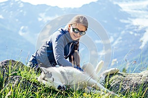 Dog with a woman walking mountains outdoors