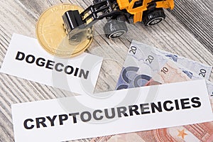 Dogecoin, miniature excavator and euro bills. Cryptocurrency. International network payment. Finance concept photo
