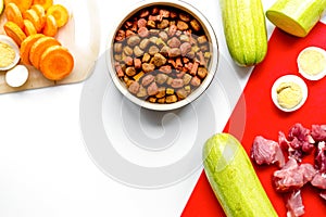 Dogfood set with vegetables, eggs and meat on table top view mock-up photo