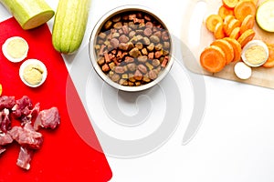 Dogfood set with vegetables, eggs and meat on table top view mock-up photo