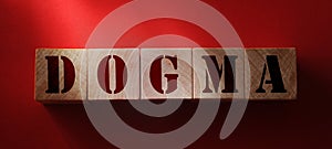 DOGMA word made with wooden letters on red background. Beliefs psychology concept